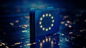 Stack of glowing blue circuit-board folders with a ring of yellow EU stars on the front, set on a reflective motherboard surface