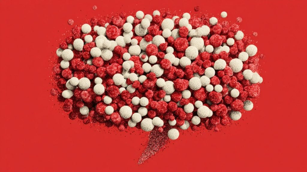 Cluster of textured red and white foam spheres arranged into a speech-bubble shape on a solid red background