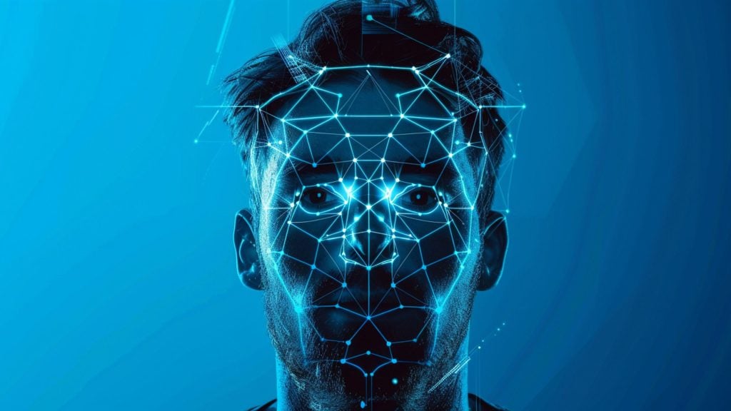 Young man's face overlaid with glowing blue facial-recognition mesh of nodes and connecting lines against a blue background