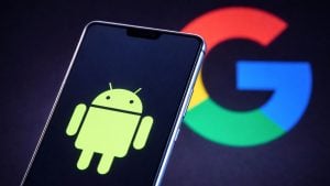 Smartphone screen showing a green Android logo against a dark background with a blurred multicolored Google "G" behind it