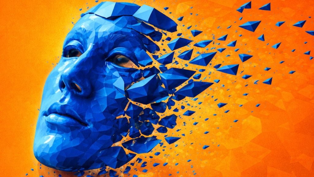 Blue low-poly human face breaking apart into floating triangular shards against a bright orange background.