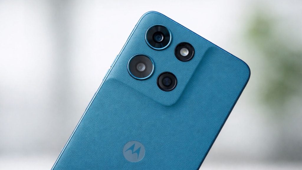 Blue textured Motorola phone back with raised square camera module holding three lenses, an LED flash and Motorola logo.