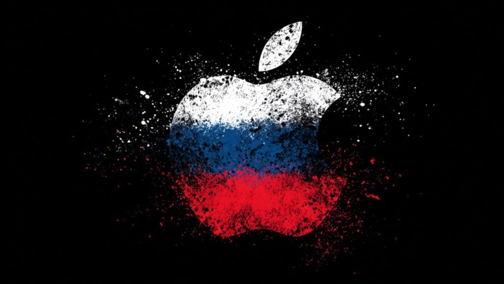 Grunge-style bitten apple logo made of white, blue, and red paint splatters on a black background.