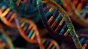 Colorful, close-up 3D rendering of DNA double helix strands made of glowing multicolored particles against a dark background