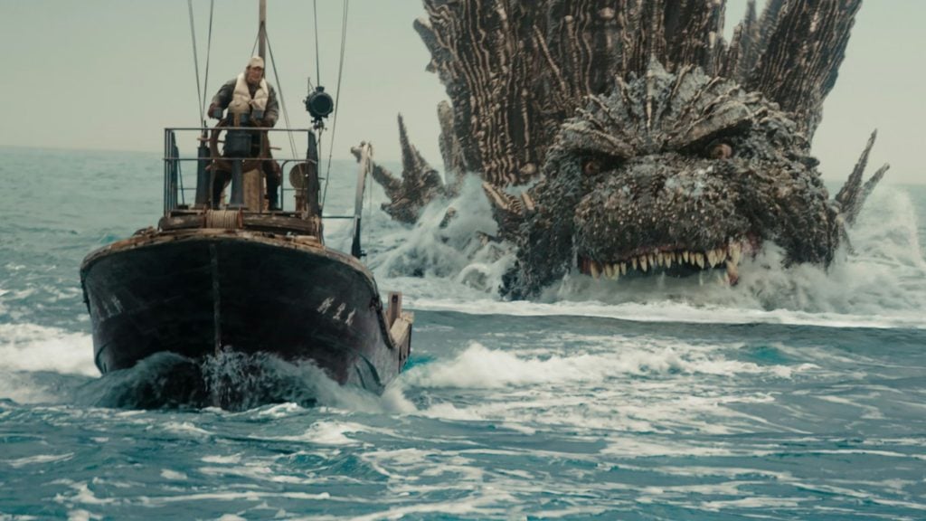 Fishing boat at sea with a terrified crewman at the helm as a giant spiky sea monster rises behind, baring teeth.