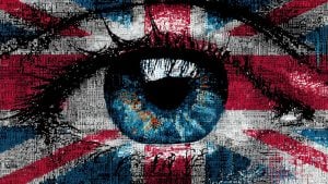 Close-up stylized blue eye with black lashes over a textured Union Jack flag made of tiny text blocks.