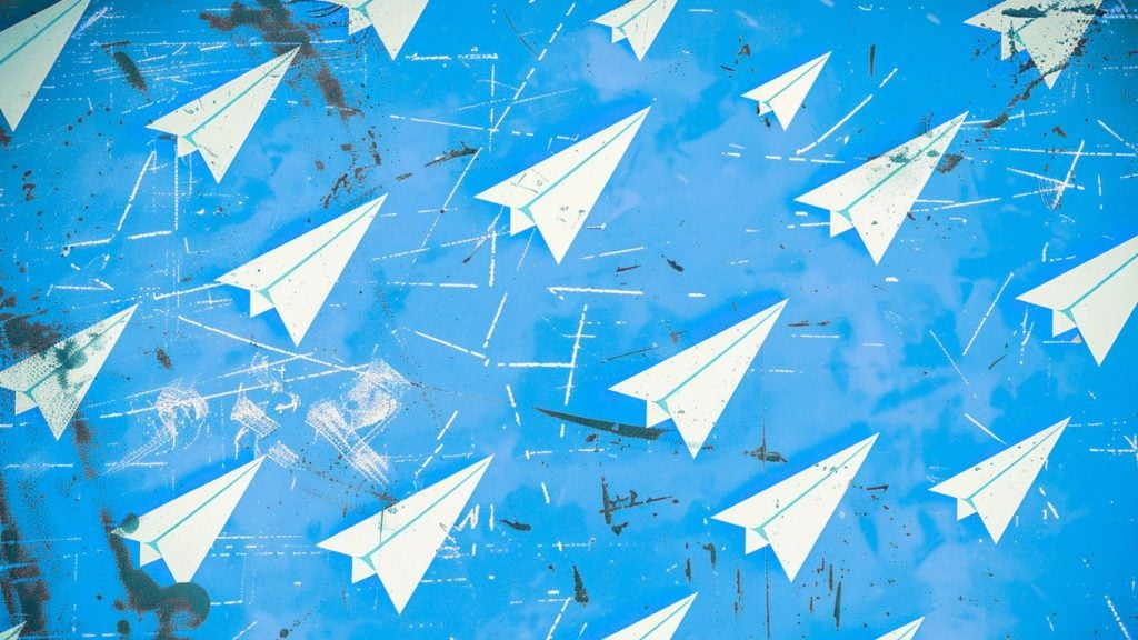 White paper airplanes flying across a textured bright blue sky with white streaks and grunge marks
