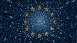 Circle of twelve yellow stars over a blue digital matrix background with radiating light and data lines