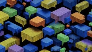 Colorful 3D speech bubbles made of small textured cubes floating against a black background.